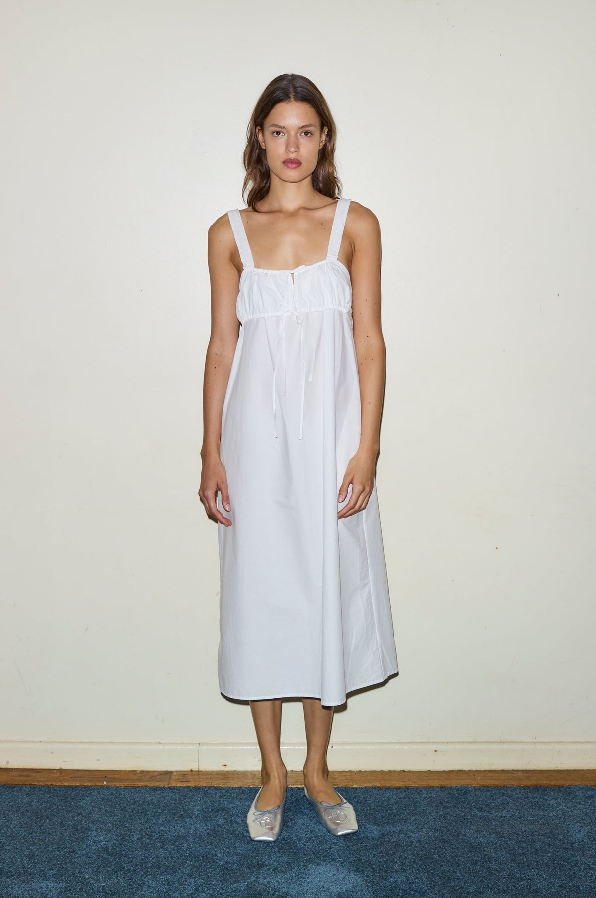 Female model wearing The Ruched Tie Dress - White by Deiji Studios against plain background