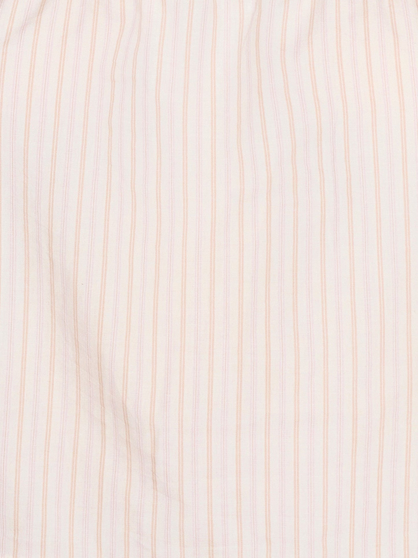 Close-up of the Simple Top - Dusty Stripe by Deiji Studios, crafted from organic cotton in white with evenly spaced, thin dusty pink vertical stripes. The fabric looks soft, slightly wrinkled, and breathable.