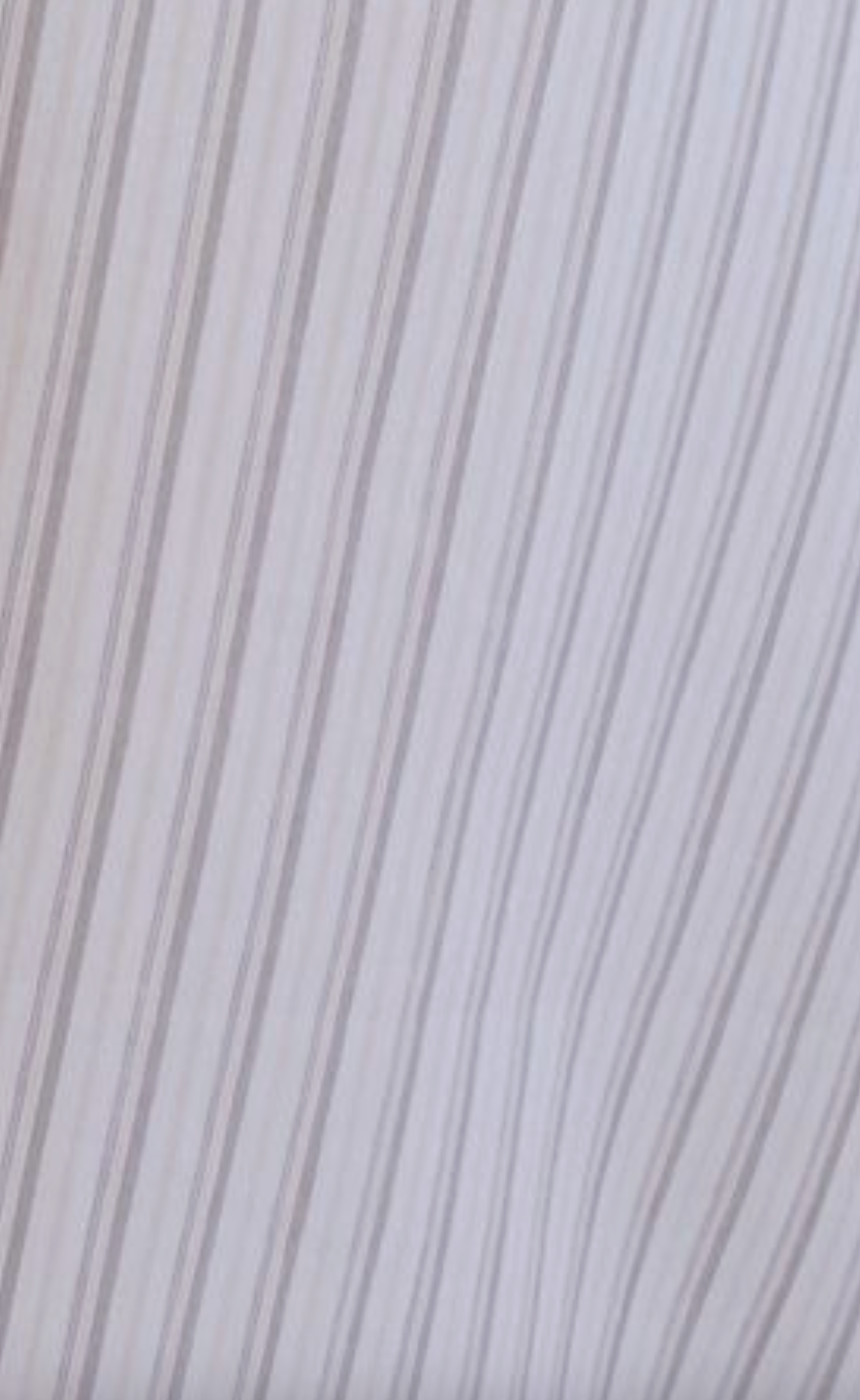 A close-up of the Button Sweep Dress - Gull Stripe, a maxi-length dress with light beige and white wavy vertical stripes that create a soft, flowing pattern.