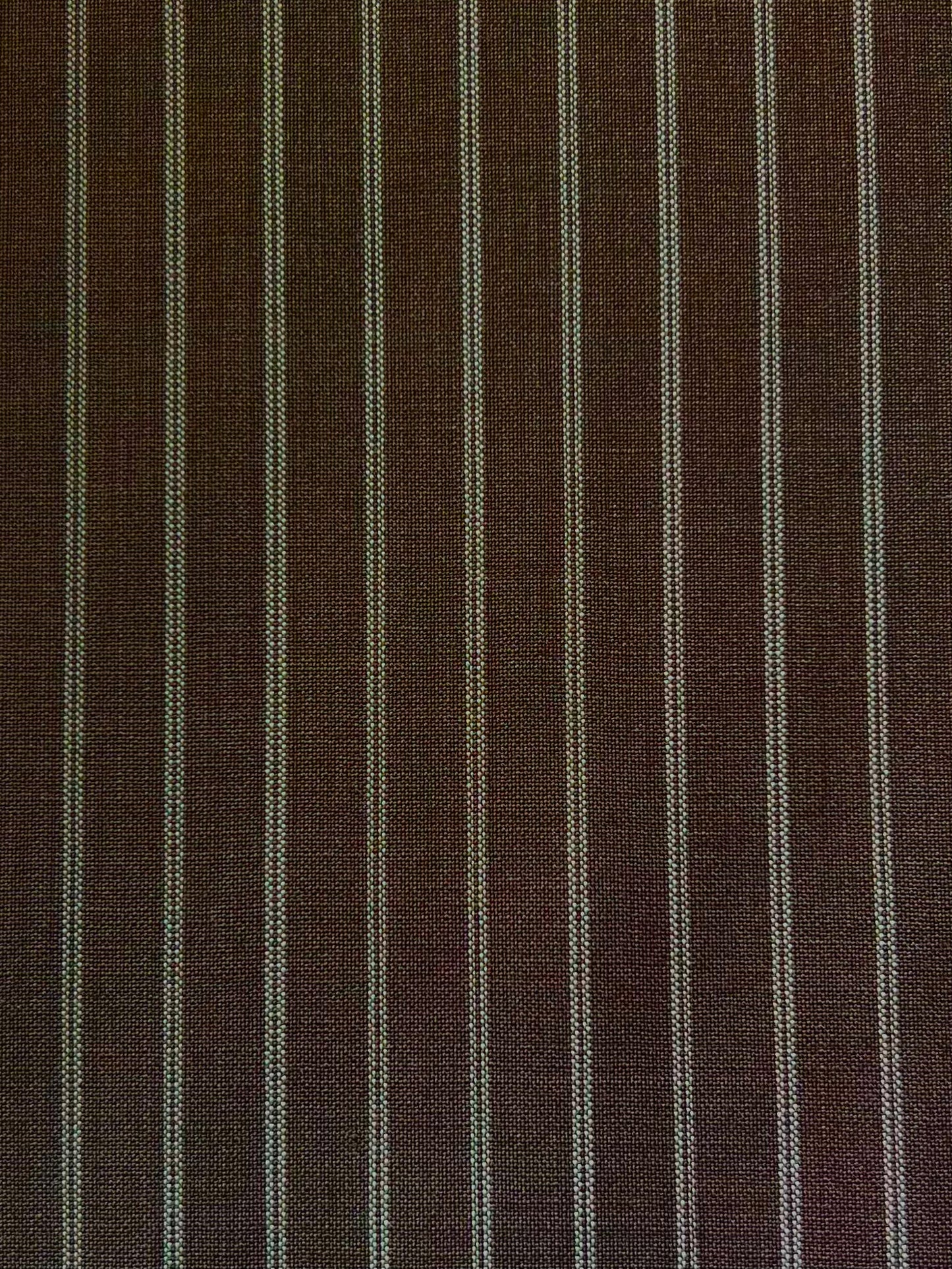 The Folded Wool Pant - Sable Stripe by 0 features evenly spaced white pinstripes on textured RWS wool, offering a timeless, slightly coarse look.