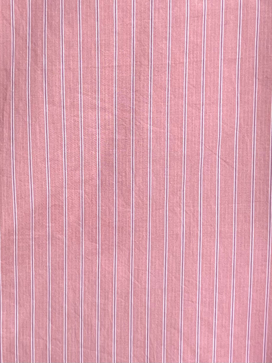 The Placket Short Set - Salt Stripe features soft pink organic cotton with thin, evenly spaced vertical white stripes—perfect for a comfortable and stylish look.