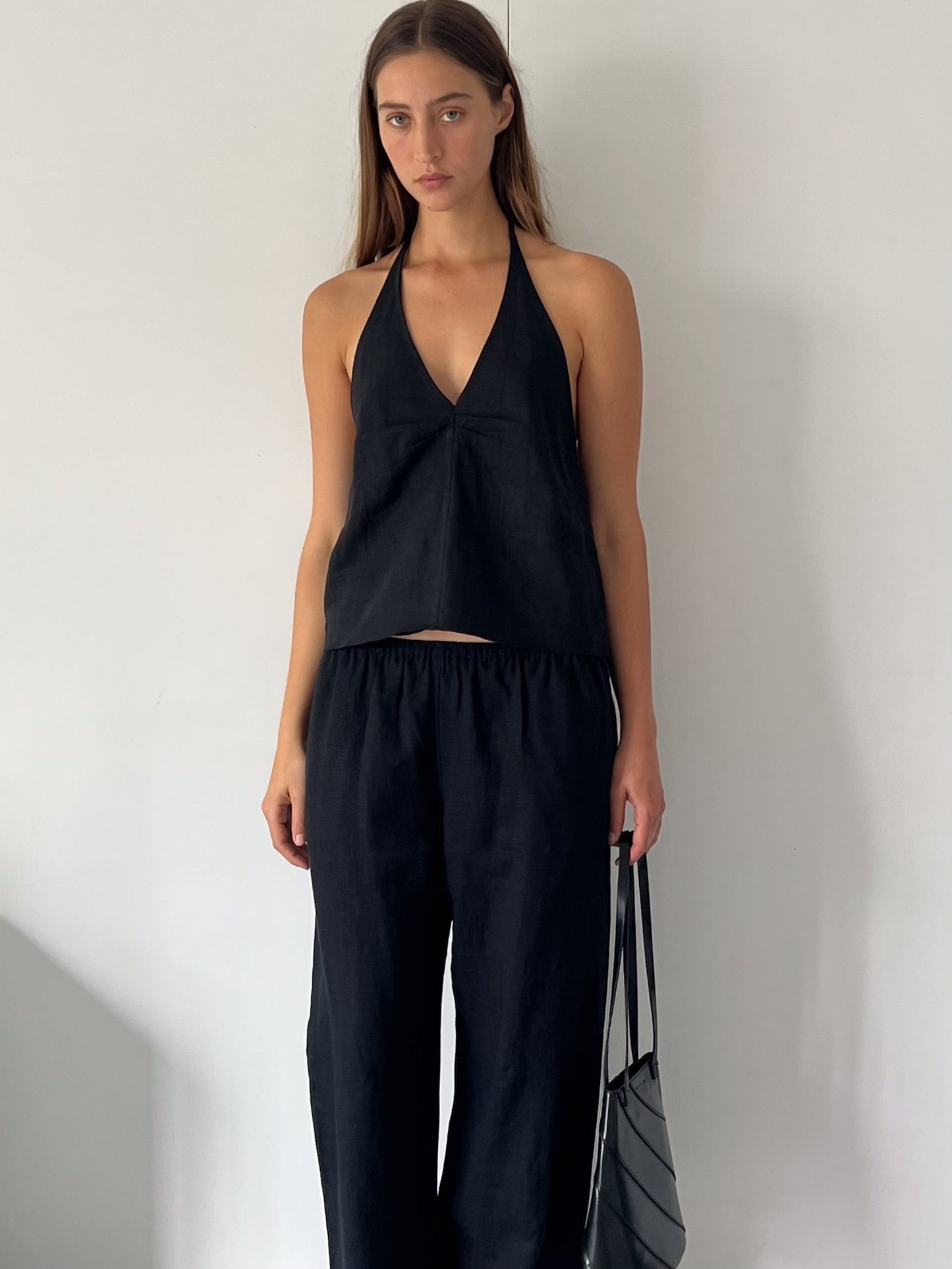 female model wears the linen pinched halter top by Deiji Studios in black
relaxed halter top features flattering v neckline, centre bust pleats and adjustable backline with drawcord tie closure
made from 100% OEKO-TEX 100 certified and EU certified stone washed french linen
paired with a black linen trouser