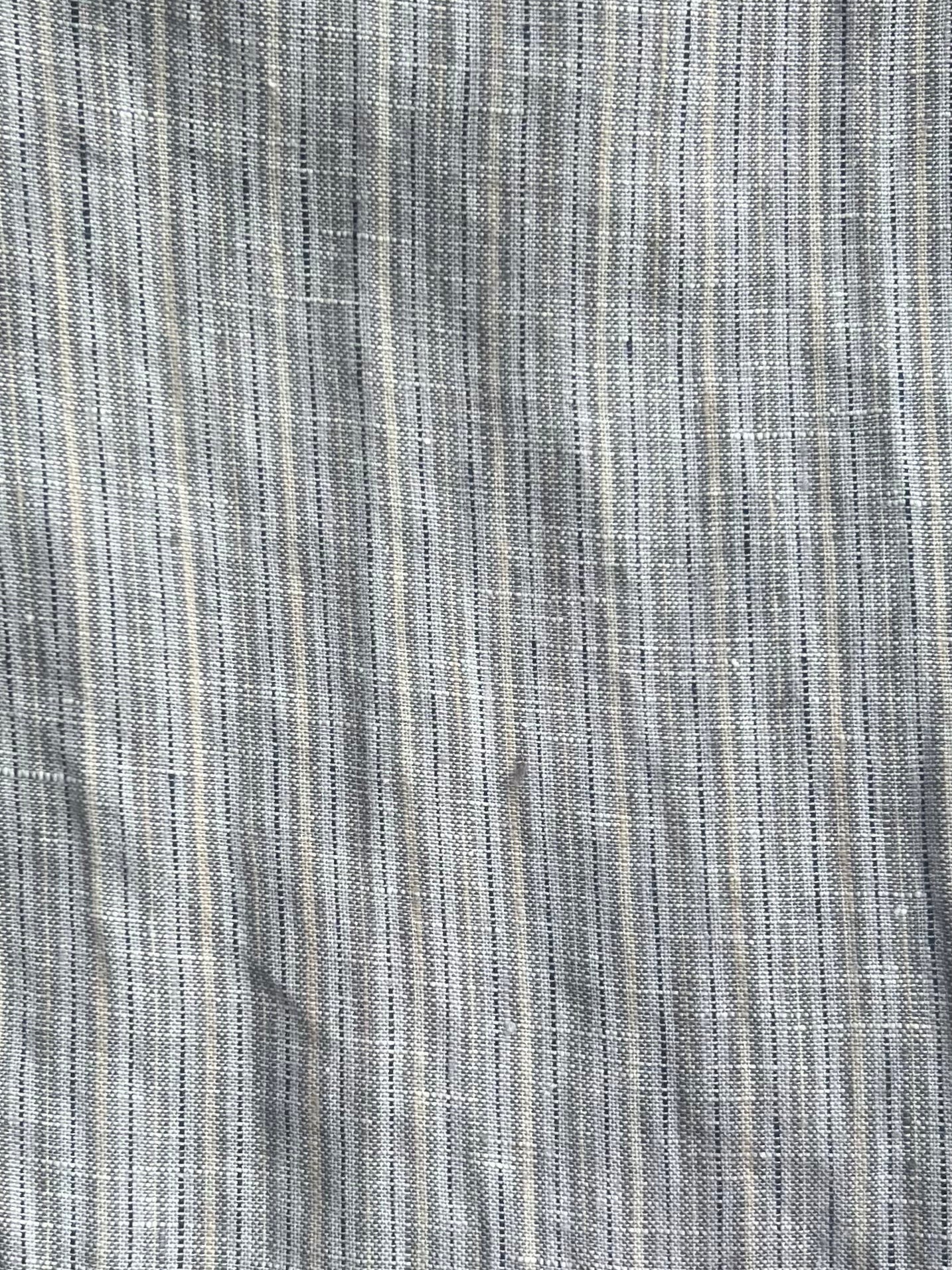 Close-up of the 03 Set - Haze Blue by 0: haze blue fabric with vertical thin stripes, subtle textured weave, and gentle shade variations—crafted from GOTS certified organic material for superior quality.