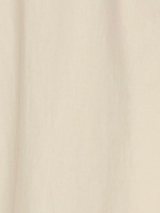 A close-up of the Light Dress - Butter White, made from light beige organic cotton with soft, vertical folds and a smooth texture.