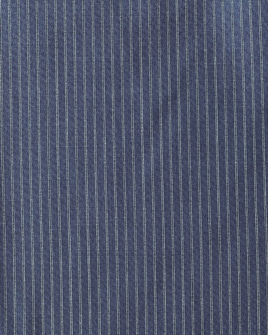 Navy striped wool fabric featuring evenly spaced thin white vertical pinstripes, similar to the Folded Wool Pant - Navy Stripe. The woven texture and precise pattern provide a refined, tailored appearance.