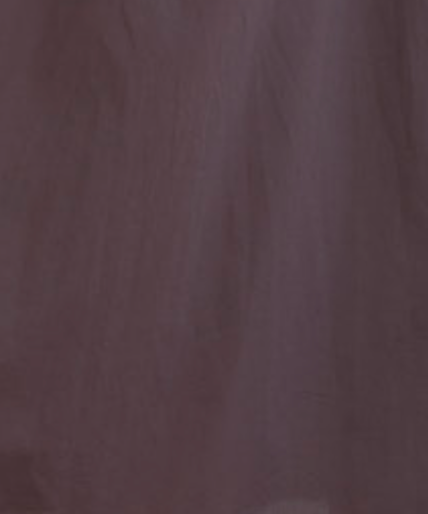 Close-up of a sheer, dark purple fabric with soft folds and a slightly translucent texture, similar to the elegant material of the Pintuck Dress - Raisin by Deiji Studios.