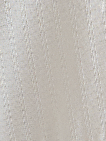 Close-up of the Maxi Skirt - White Texture by Deiji Studios, featuring cream-colored fabric with subtle vertical stripes that lend elegant texture and a refined look to this soft, white maxi skirt.