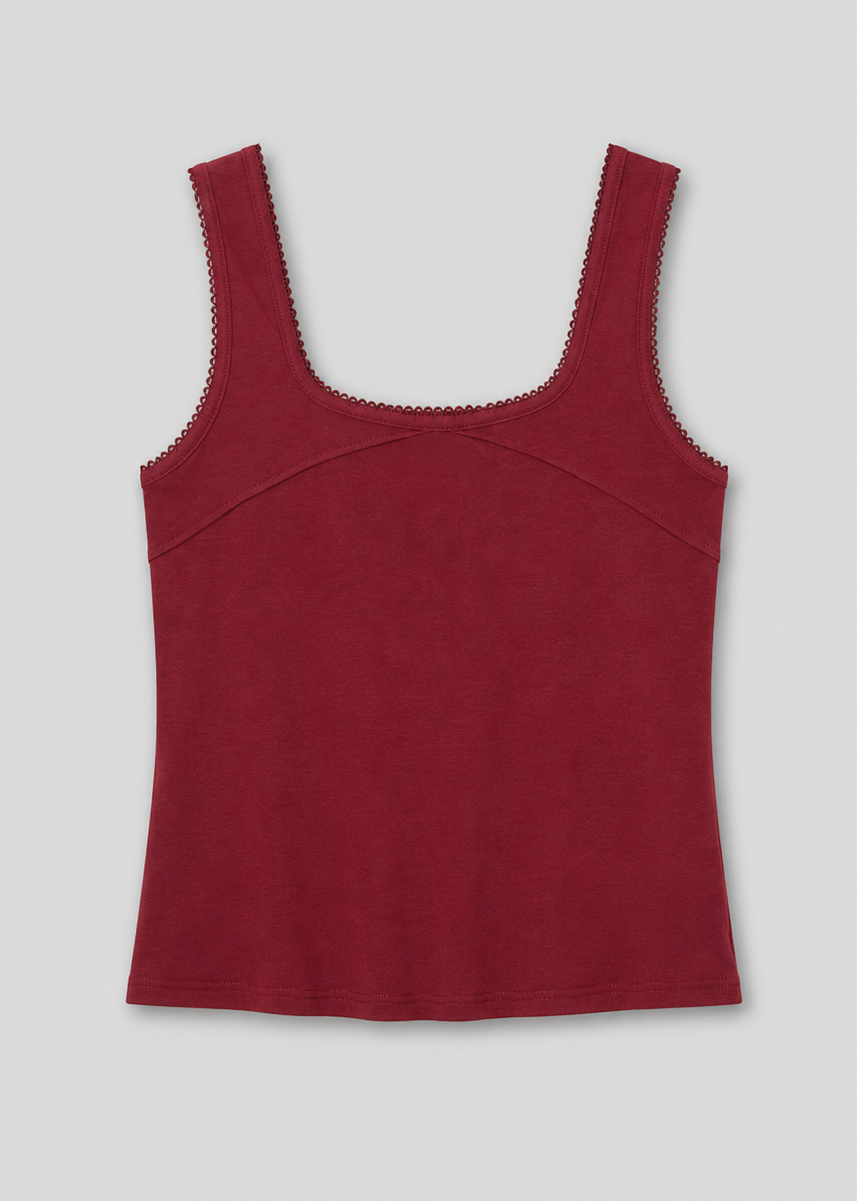 The Piping Tank - Crimson is a sleeveless, square-neckline top in dark red with scalloped trim on the neckline and armholes, shown flat on a light background—a chic style inspired by Deiji Studios.