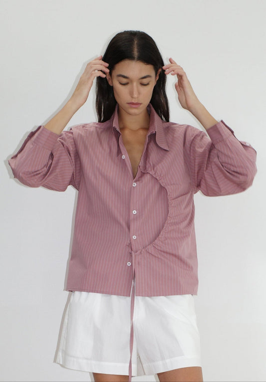 female model wears the arch tie shirt by Deiji Studios in salt stripe


a classic crisp button up shirt in a boxy fit, featuring a dropped back yoke, dropped shoulders, a classic shirting cuff with a layered arch fabric detail on front with tie


made from 100% GOTS certified organic cotton poplin

paired with a white cotton short