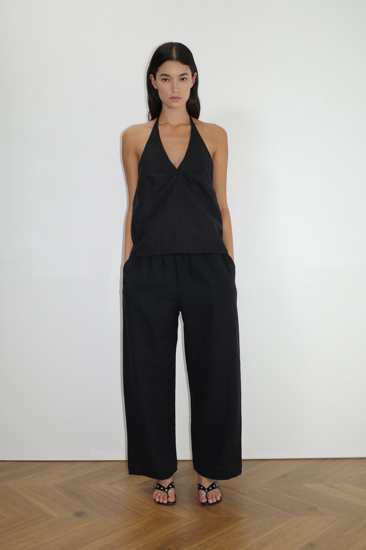 female model wears the linen ease trouser by Deiji Studios in black


the ankle length pant features a soft minimal elastic waist with side seam pockets in a straight leg


can be worn at home, in bed, or out

made from 100% GOTS certified organic, OEKO-TEX 100 certified and EU certified stone washed french linen

paired with a black linen halter top