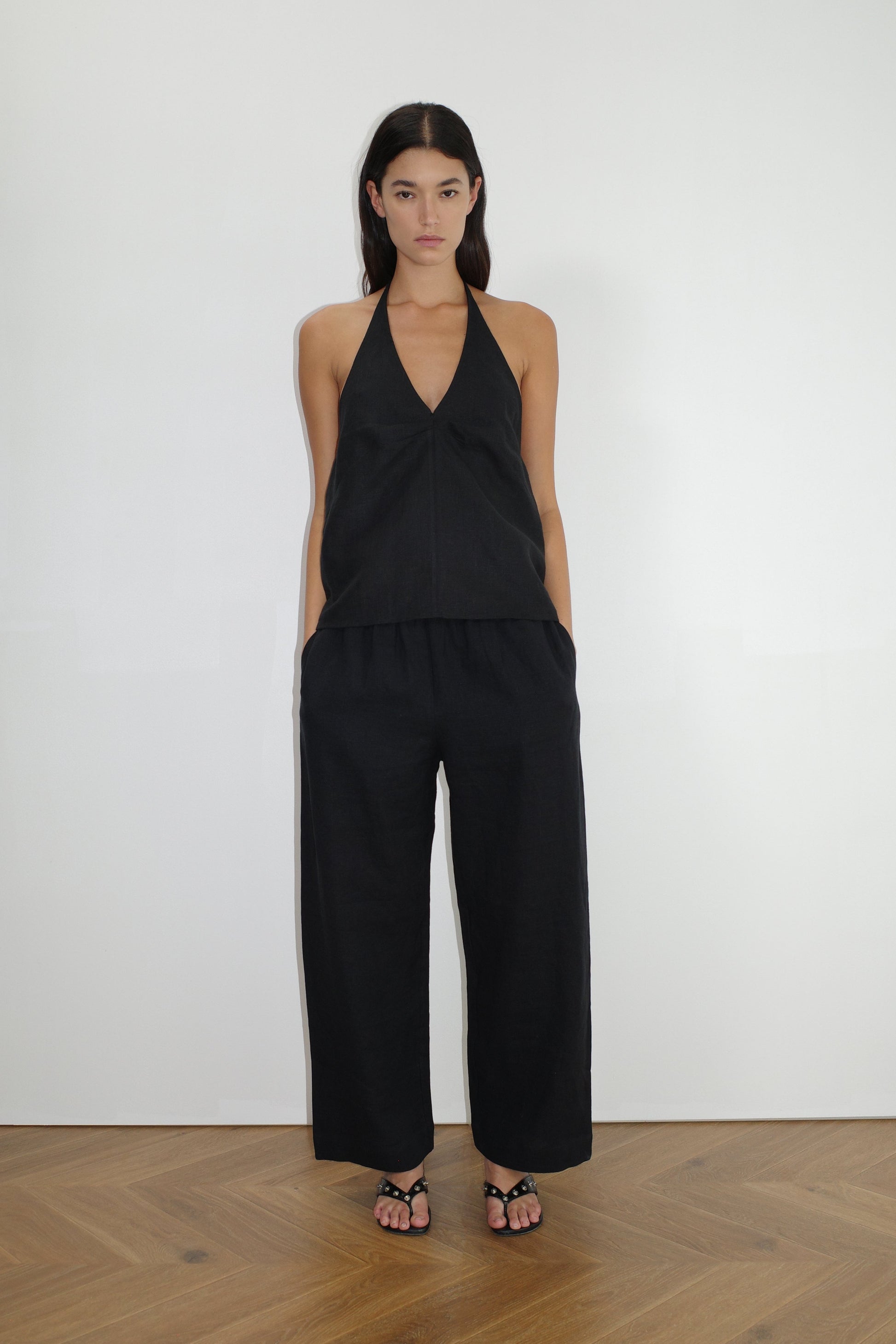 female model wears the linen ease trouser by Deiji Studios in black


the ankle length pant features a soft minimal elastic waist with side seam pockets in a straight leg


can be worn at home, in bed, or out

made from 100% GOTS certified organic, OEKO-TEX 100 certified and EU certified stone washed french linen

paired with a black linen halter top