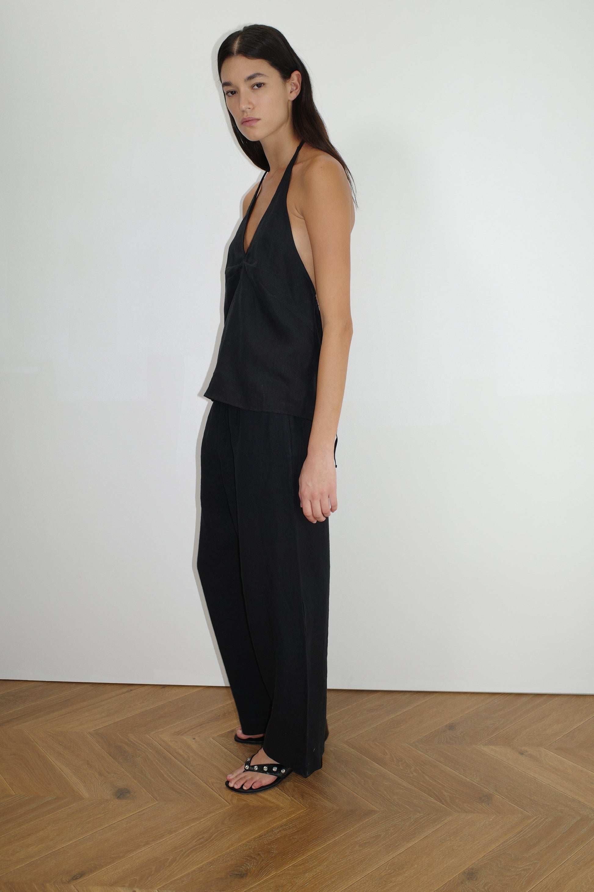 female model wears the linen ease trouser by Deiji Studios in black


the ankle length pant features a soft minimal elastic waist with side seam pockets in a straight leg


can be worn at home, in bed, or out

made from 100% GOTS certified organic, OEKO-TEX 100 certified and EU certified stone washed french linen

paired with a black linen halter top