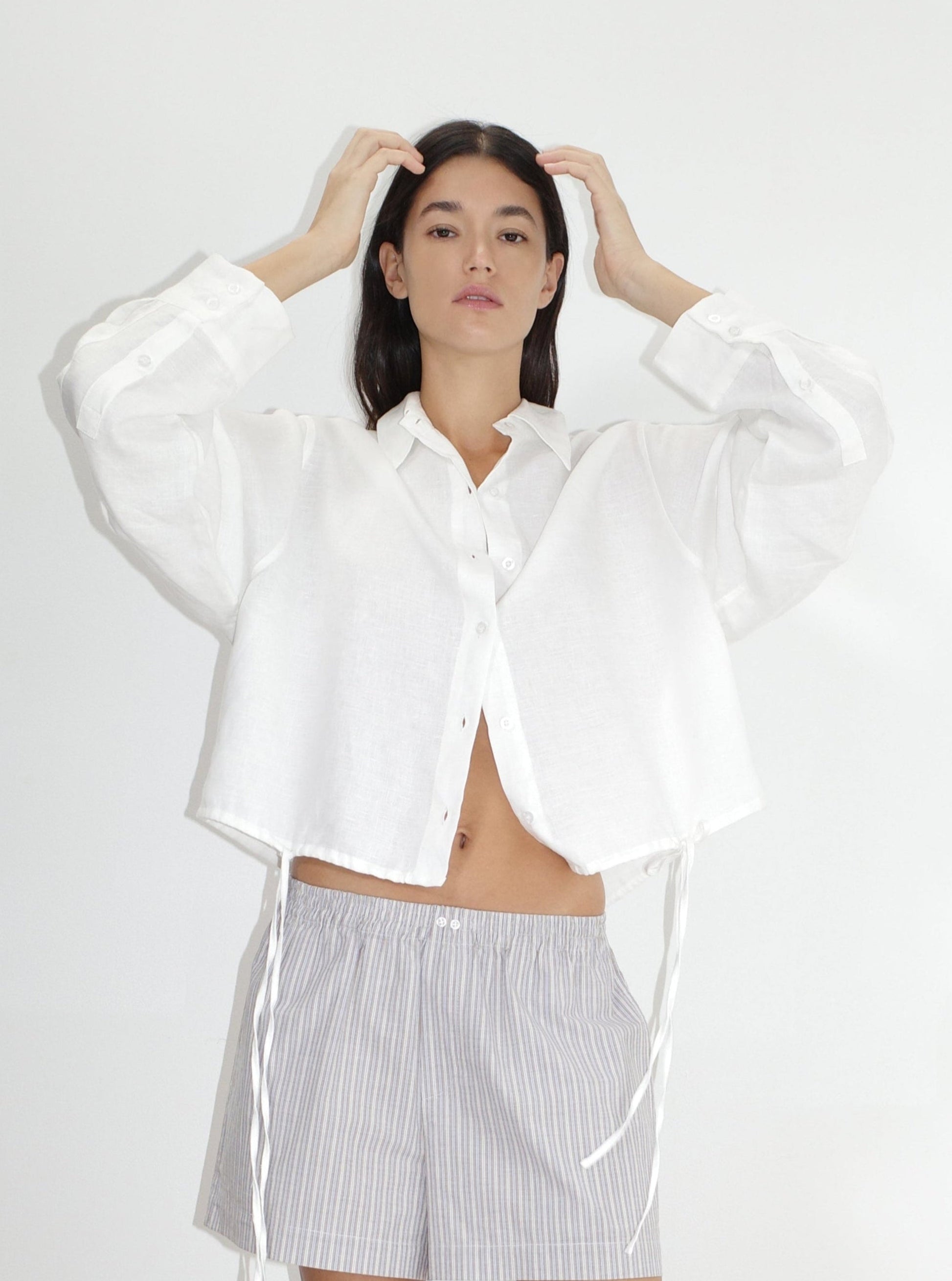 female model wears the hem shirt by Deiji Studios in white


a classic button up style shirt featuring a drawcord tie channel at bottom hem, dropped back yoke and dropped shoulder for a relaxed fit


made from 100% OEKO-TEX 100 certified and EU certified stone washed french linen

paired with boxer short in seas stripe