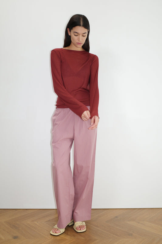 female model wears the ease trouser by Deiji Studios in salt stripe


the ankle length pant features a soft minimal elastic waist with side seam pockets in a straight leg


can be worn at home, in bed, or out


made from 100% GOTS certified organic cotton poplin

paired with a sheer long sleeve knit in crimson red
