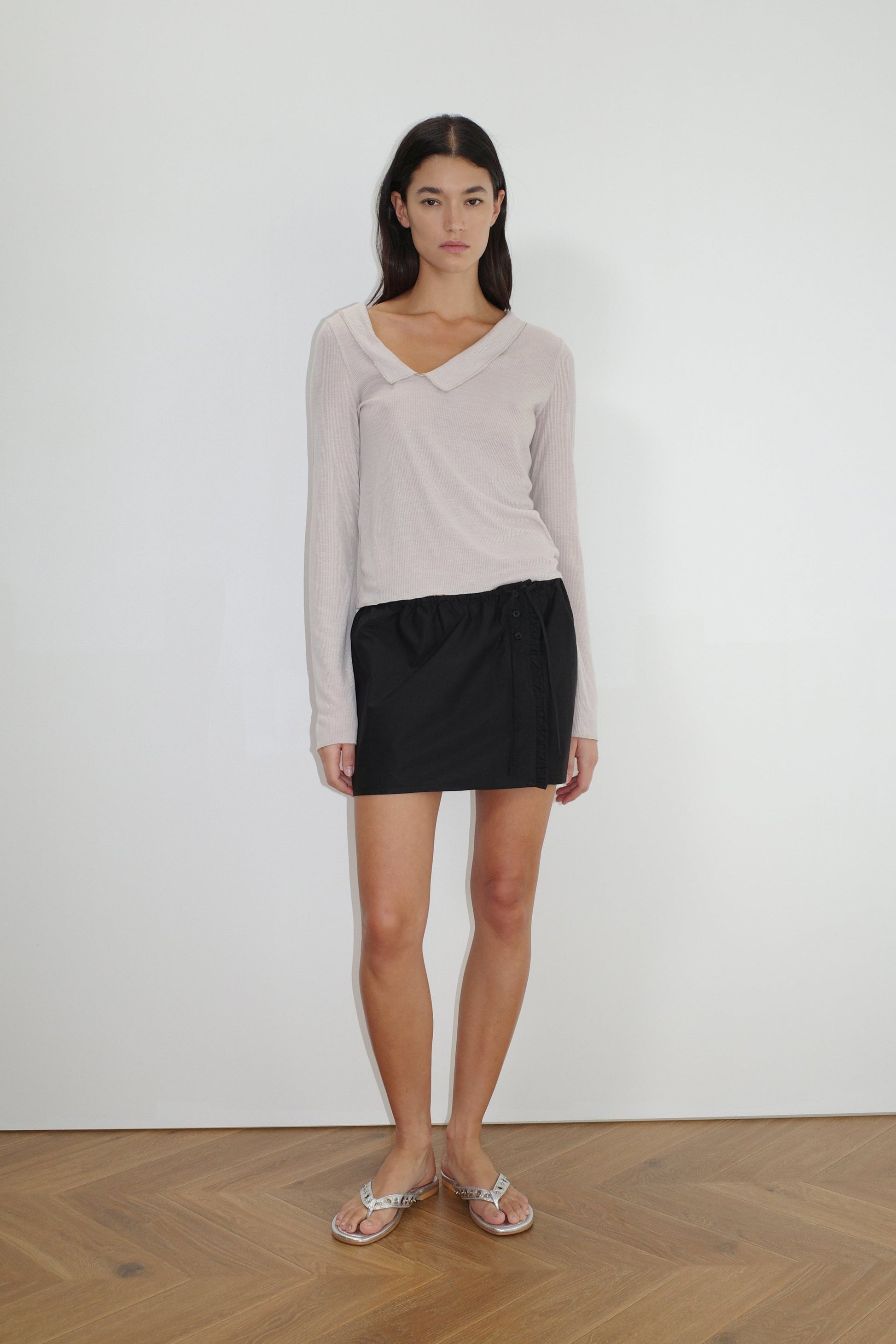 female model wears the cross collar top by Deiji Studios in shell


a sheer fine knit long sleeved top with asymmetric collared neckline, featuring baby locked finishes and a relaxed fit


made from a responsible blend of 85% Recycled Polyester and 15% Viscose

paired with a black cotton skirt