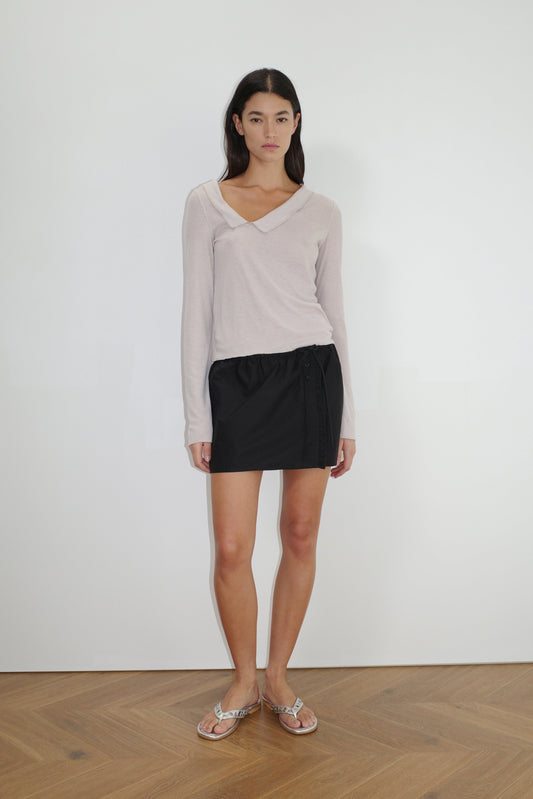 female model wears the cross collar top by Deiji Studios in shell


a sheer fine knit long sleeved top with asymmetric collared neckline, featuring baby locked finishes and a relaxed fit


made from a responsible blend of 85% Recycled Polyester and 15% Viscose

paired with a black cotton skirt