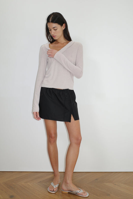 female model wears the cross collar top by Deiji Studios in shell


a sheer fine knit long sleeved top with asymmetric collared neckline, featuring baby locked finishes and a relaxed fit


made from a responsible blend of 85% Recycled Polyester and 15% Viscose

paired with a black cotton skirt