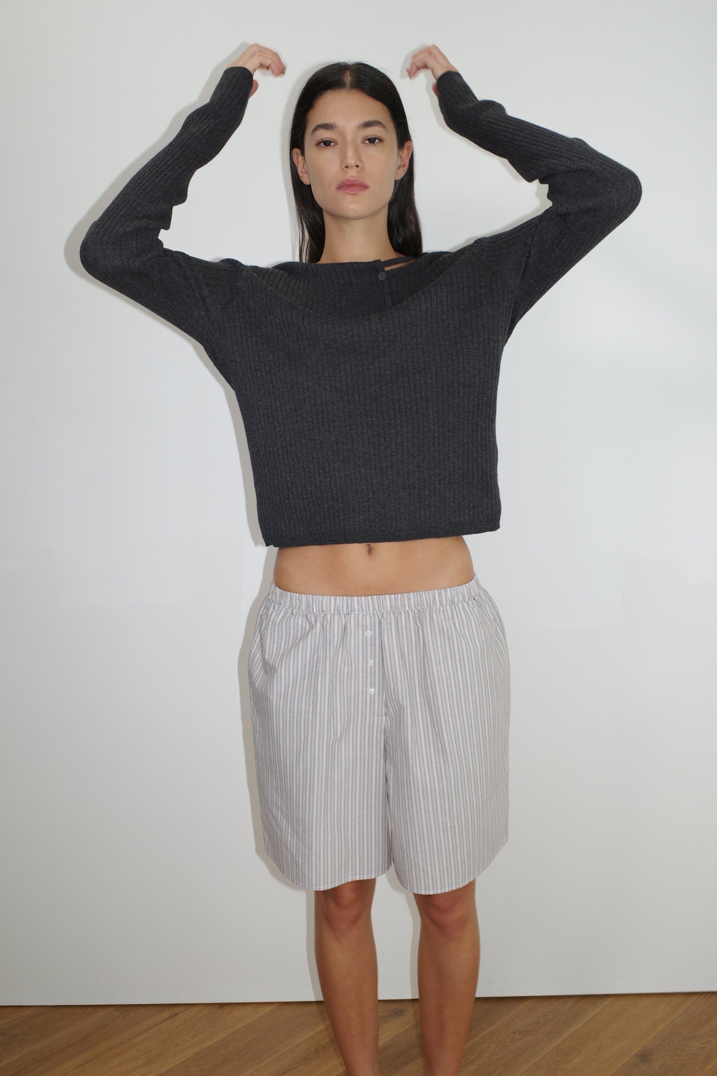female model wears restocking soon, sign up to be notified


the cut out cardi by Deiji Studios in coal


a fully fashioned ribbed knit features flattering high neckline, cut out collar with single button feature in a relaxed loose fit


made from 95% BCI cotton and 5% cashmere

paired with the long boxer in seas stripe