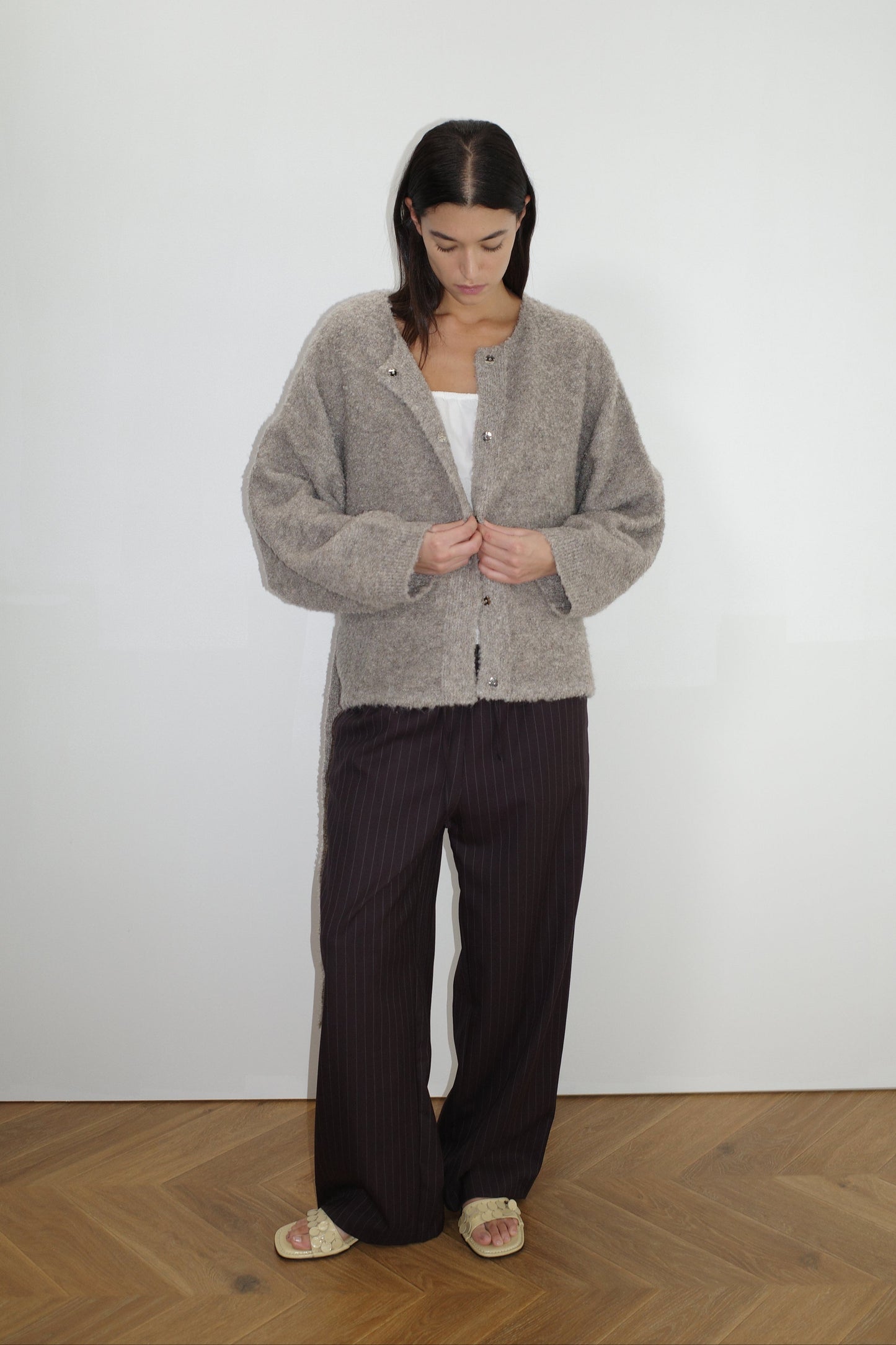 female model wears the pod knit by Deiji Studios in cloud grey


a relaxed and textured knit features a round shaped neckline with press stud front closure, removable self tie belt with long sleeves and high back neckline


made from a sustainable knit blend of 12% RWS certified wool, 30% recycled acrylic, 64% recycled polyester and 4% spandex

paired with a pinstripe wool pant