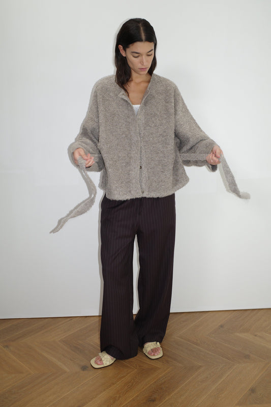female model wears the pod knit by Deiji Studios in cloud grey


a relaxed and textured knit features a round shaped neckline with press stud front closure, removable self tie belt with long sleeves and high back neckline


made from a sustainable knit blend of 12% RWS certified wool, 30% recycled acrylic, 64% recycled polyester and 4% spandex

paired with a pinstripe wool pant