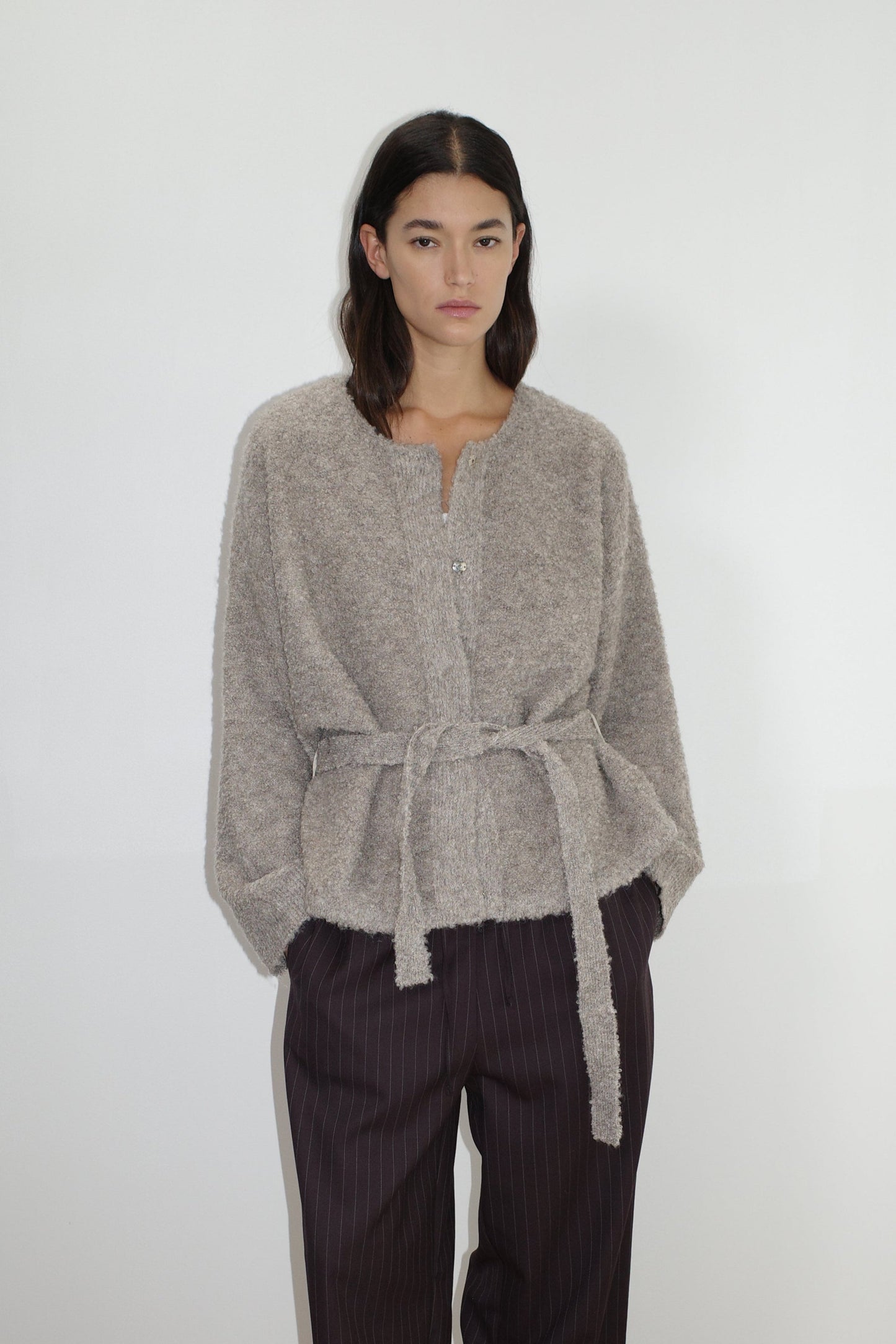 female model wears the pod knit by Deiji Studios in cloud grey


a relaxed and textured knit features a round shaped neckline with press stud front closure, removable self tie belt with long sleeves and high back neckline


made from a sustainable knit blend of 12% RWS certified wool, 30% recycled acrylic, 64% recycled polyester and 4% spandex

paired with a pinstripe wool pant