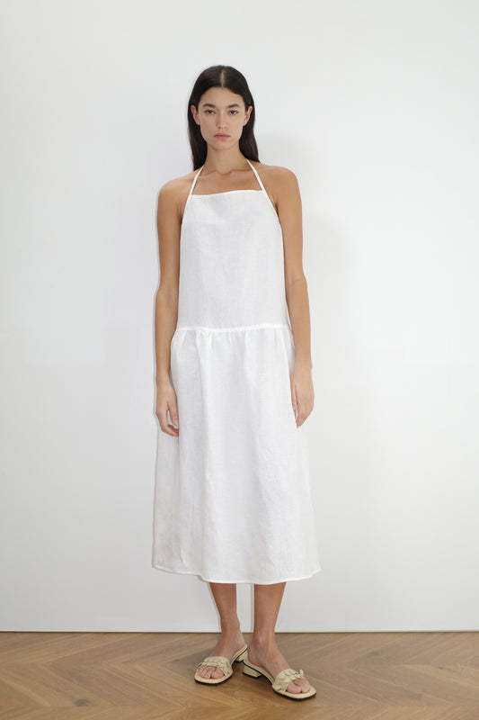 female model wears the gathered halter dress by Deiji Studios in white


a relaxed mid-length dress featuring a drop waist with soft gathered skirt. gathering under the armholes and adjusttable tie straps at back


crafted from 100% OEKO-TEX 100 certified and EU-certified stone-washed french linen, offering a luxurious and breathable feel