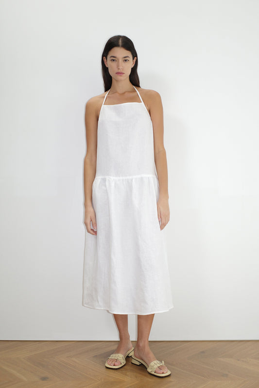 female model wears the gathered halter dress by Deiji Studios in white


a relaxed mid-length dress featuring a drop waist with soft gathered skirt. gathering under the armholes and adjusttable tie straps at back


crafted from 100% OEKO-TEX 100 certified and EU-certified stone-washed french linen, offering a luxurious and breathable feel