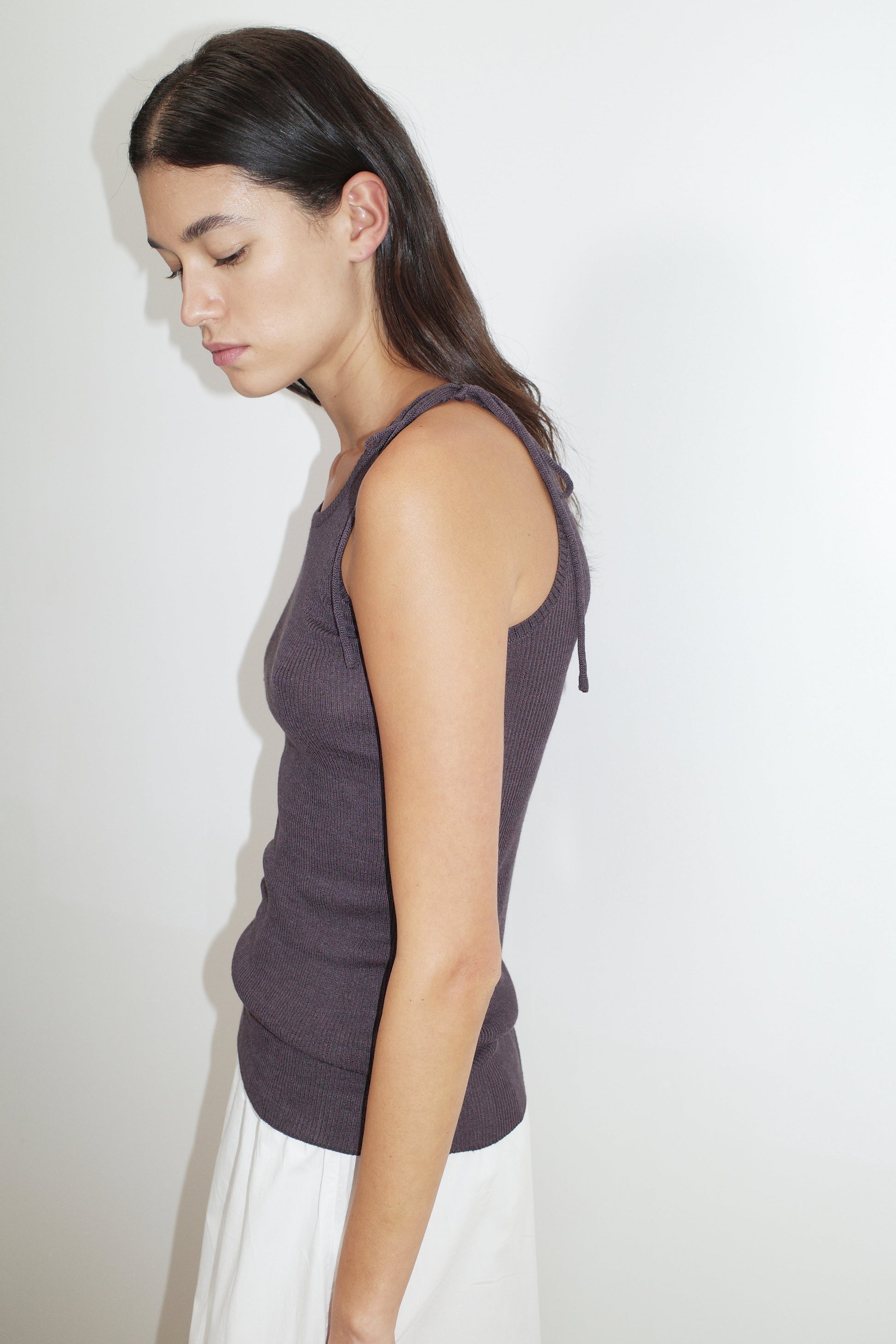 female model wears the one tie top by Deiji Studios in eggplant


a minimalist, fully fashioned tank-style knit top featuring asymmetrical tie strap design made with a lightweight ribbed texture


made from 90% eco-viscose and 10% linen

paired with a white cotton skirt