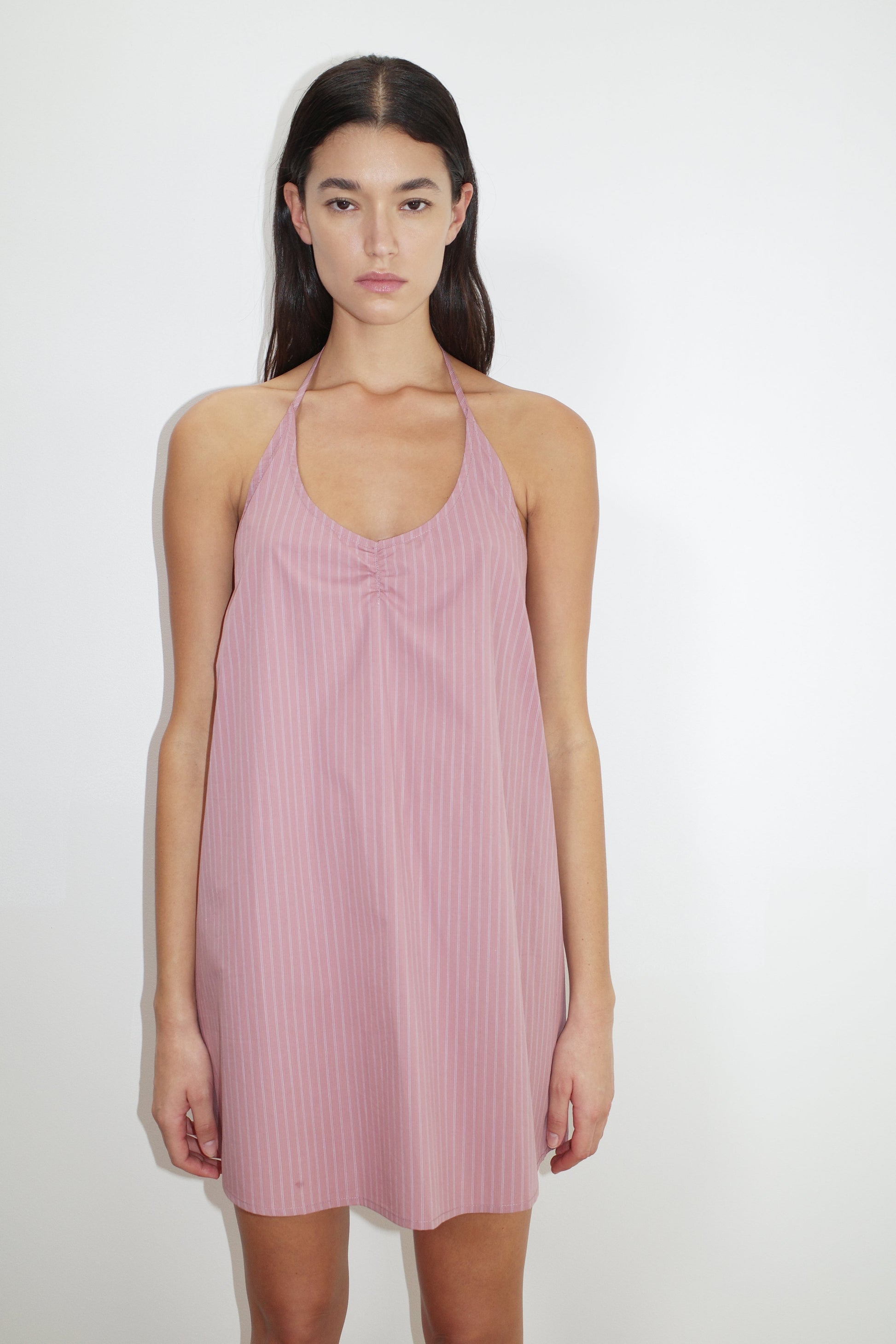 female model wears the round halter dress by Deiji Studios in salt stripe


a short-length, halter dress featuring a rounded v neckline with adjustable ties around the neck. designed with external centre front tucks created by an internal elastic. the back neckline includes a keyhole detail with functional ties


made from 100% organic cotton poplin