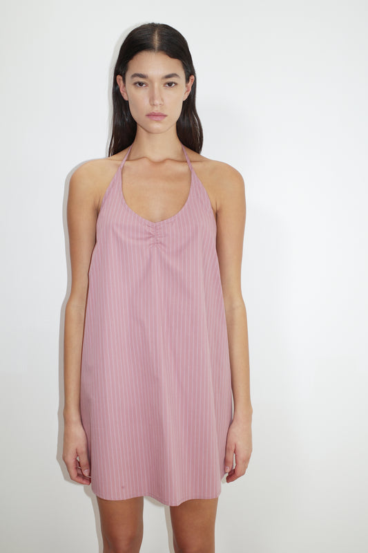 female model wears the round halter dress by Deiji Studios in salt stripe


a short-length, halter dress featuring a rounded v neckline with adjustable ties around the neck. designed with external centre front tucks created by an internal elastic. the back neckline includes a keyhole detail with functional ties


made from 100% organic cotton poplin