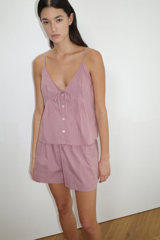 female model wears the placket short set by Deiji Studios in salt stripe


a lightweight everyday top features a flattering v neckline, button down front, side fold pleat detail at bust with a self-fabric tie pairs back with an easy pull on short, featuring a soft elastic waist and side seam pockets to wear as a set or separately


made from 100% organic cotton poplin