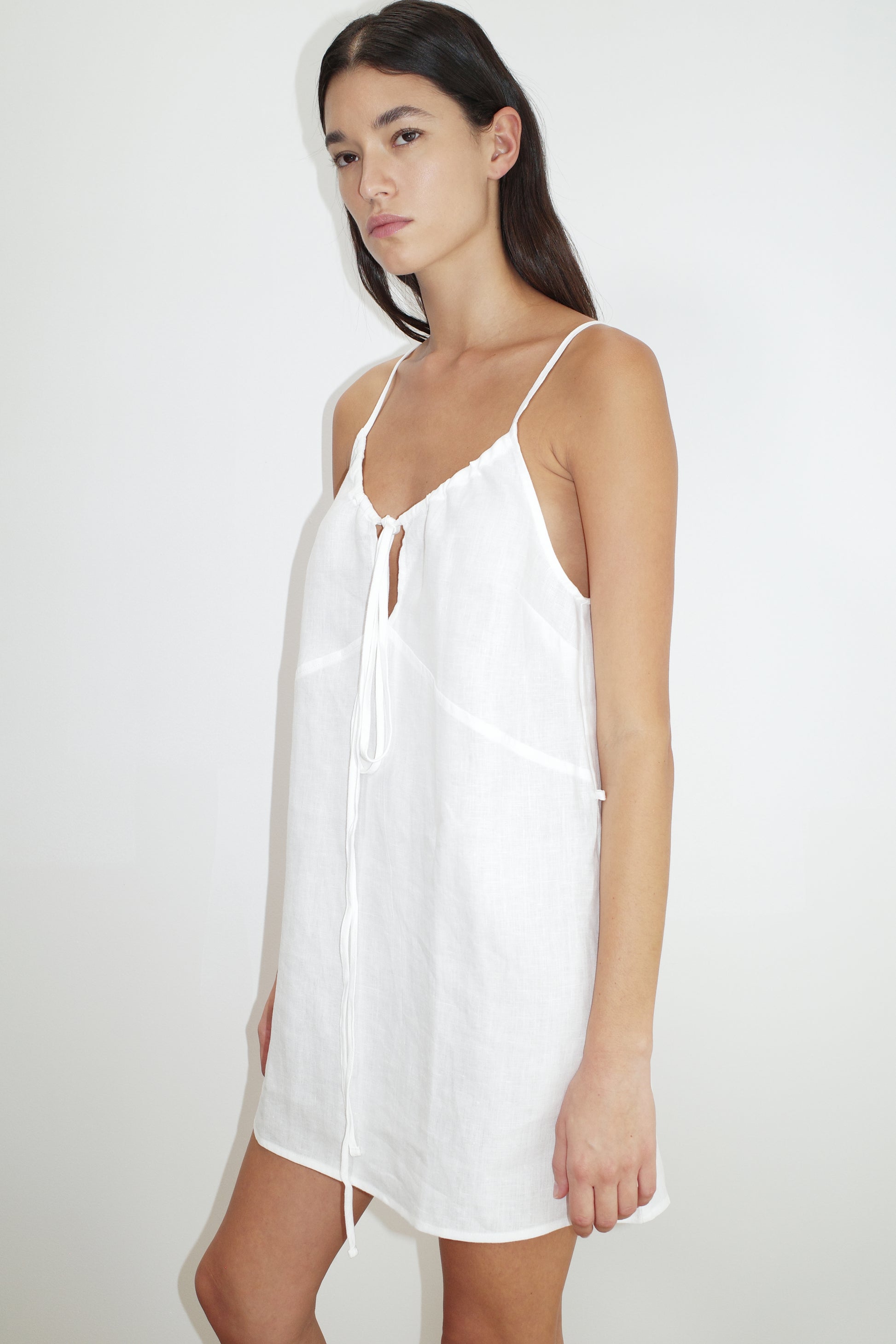 female model wears the tie front dress by Deiji Studios in white


elevated day dress in a mini length features a v neckline, fine self fabric straps at shoulder, and dropped v backline


made from 100% GOTS certified organic, OEKO-TEX 100 certified and EU certified stone washed french linen
