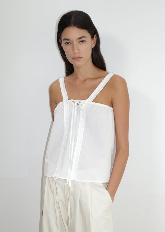 the ruffle strap top by Deiji Studios in white


a relaxed-fit top featuring self-fabric ruffles along the straps and center front, with a tie front detail. designed with elasticated gathering for ease and comfort


made from 100% organic cotton poplin

paired with a off white cotton trouser