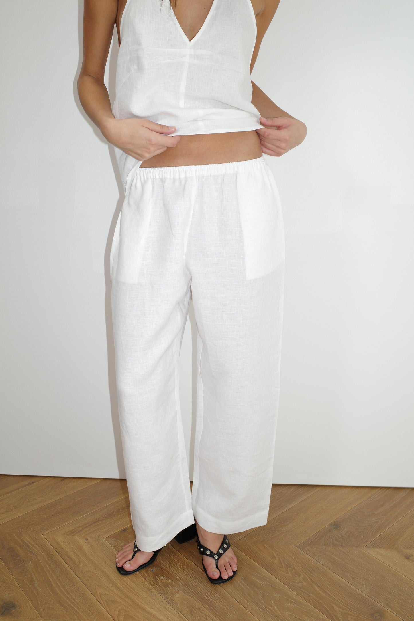 female model wears the linen ease trouser by Deiji Studios in white


the ankle length pant features a soft minimal elastic waist with side seam pockets in a straight leg


can be worn at home, in bed, or out

made from 100% GOTS certified organic, OEKO-TEX 100 certified and EU certified stone washed french linen

paired with a white linen halter top