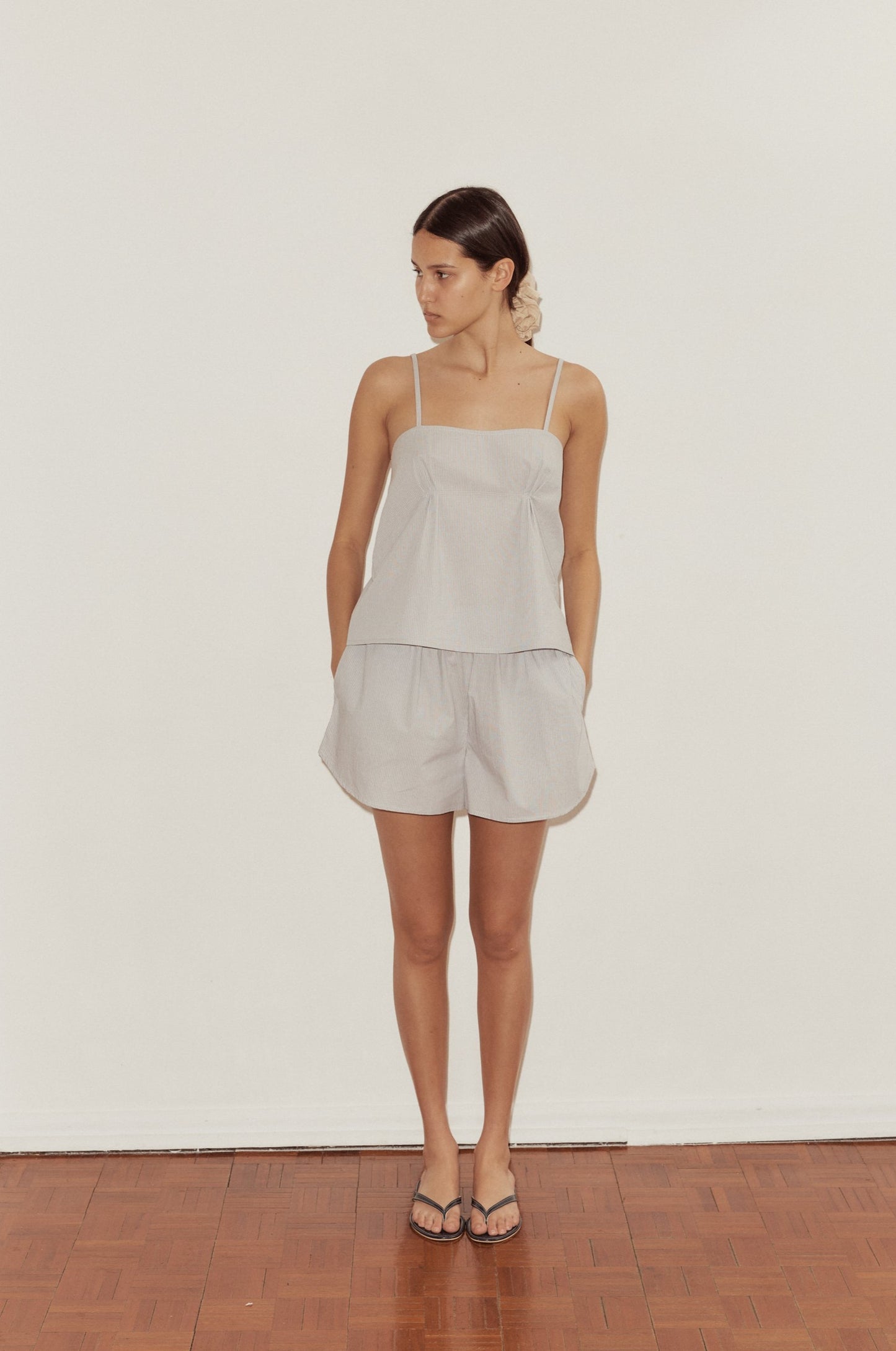 Female model wearing Pleat Set - Dream Stripe by Deiji Studios against plain background