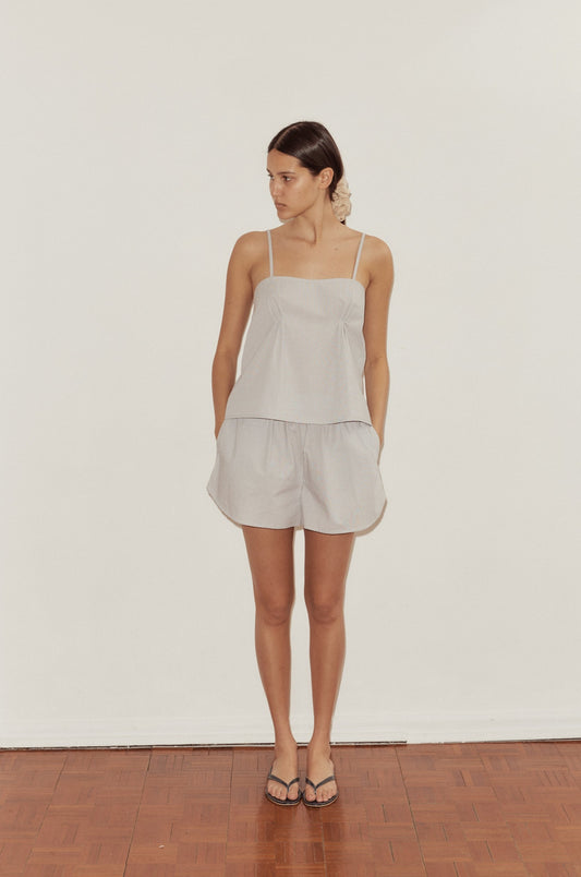 Female model wearing Pleat Set - Dream Stripe by Deiji Studios against plain background