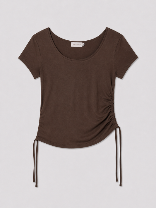 The Draw Side Tee - Brown by Deiji Studios, a brown short-sleeve cotton jersey top with a round neckline and adjustable drawcord ties at the side hem, displayed flat against a plain light background.