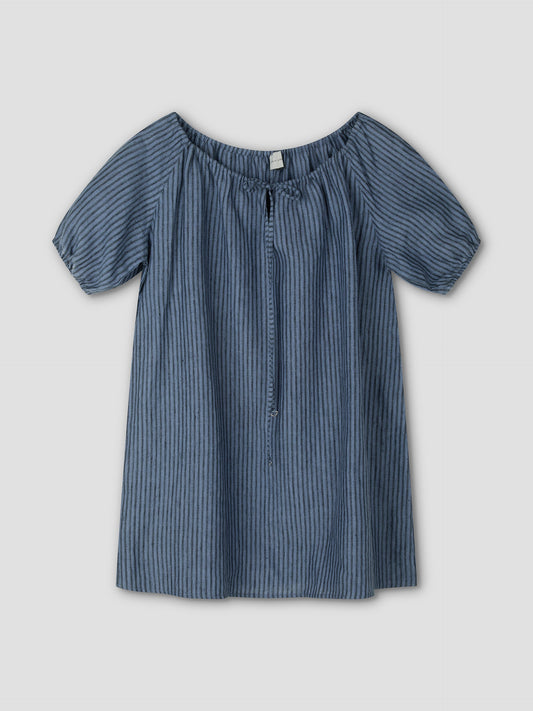 The Smock Dress - Azure Stripe by Deiji Studios is a short-sleeved, loose-fitting mini dress with vertical blue stripes, an elastic off-the-shoulder neckline, a front tie, and lightweight fabric for a casual style.