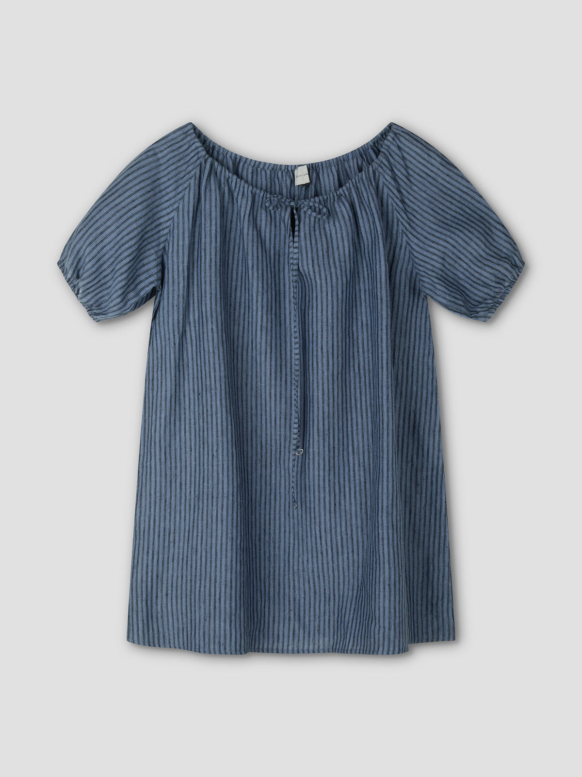 The Smock Dress - Azure Stripe by Deiji Studios is a short-sleeved, loose-fitting mini dress with vertical blue stripes, an elastic off-the-shoulder neckline, a front tie, and lightweight fabric for a casual style.