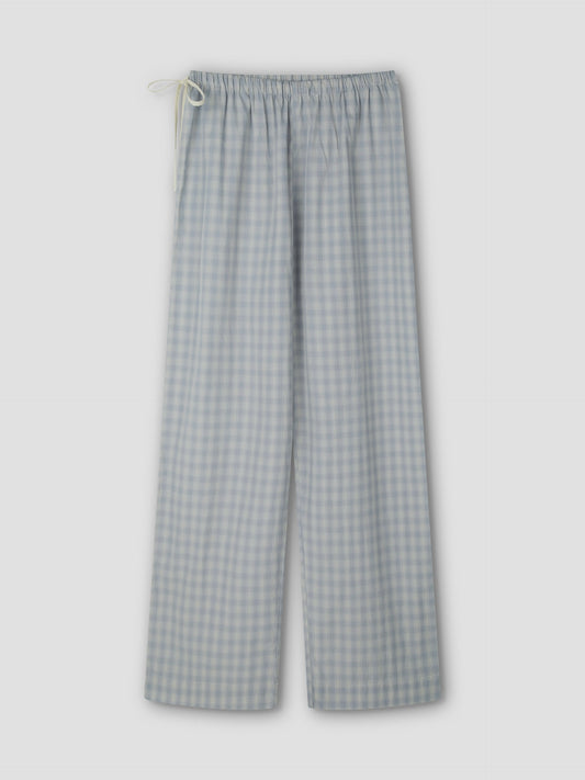 The Side Tie Pant - Blue Check features light blue and white cotton poplin in a check pattern and a drawstring waistband, shown flat against a plain light gray background.