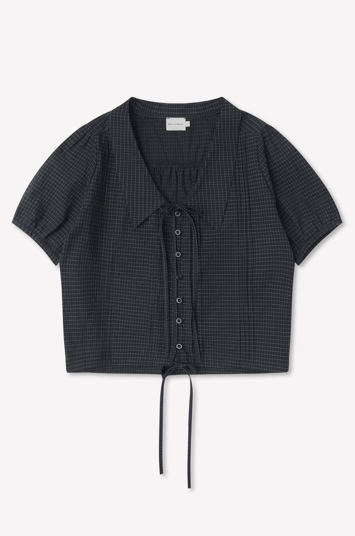 The Fine Collar Top - Mono Grid is a short-sleeved, charcoal gray cotton poplin top with a subtle grid pattern, collared v-neck, and drawstring at the cropped hem, shown laid flat on a white background.