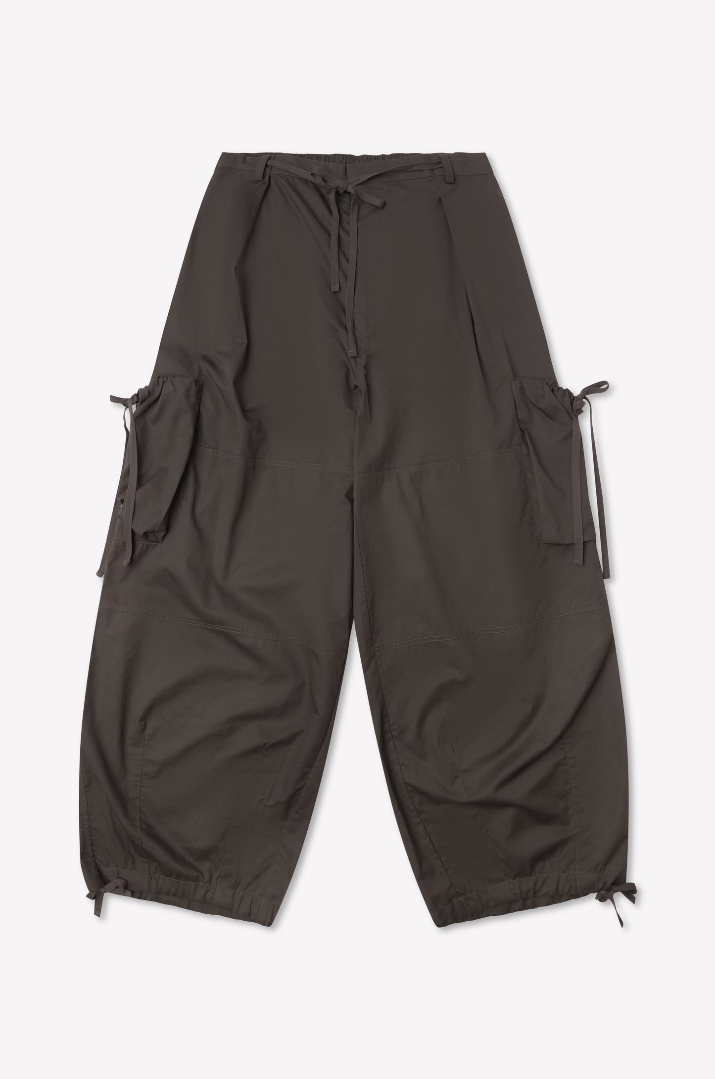 The Cargo Pant - Carob by Deiji Studios is a loose-fitting dark brown cargo pant with large side pockets, adjustable waist and ankle drawstrings, and wide-leg silhouette, shown flat on a plain white background.