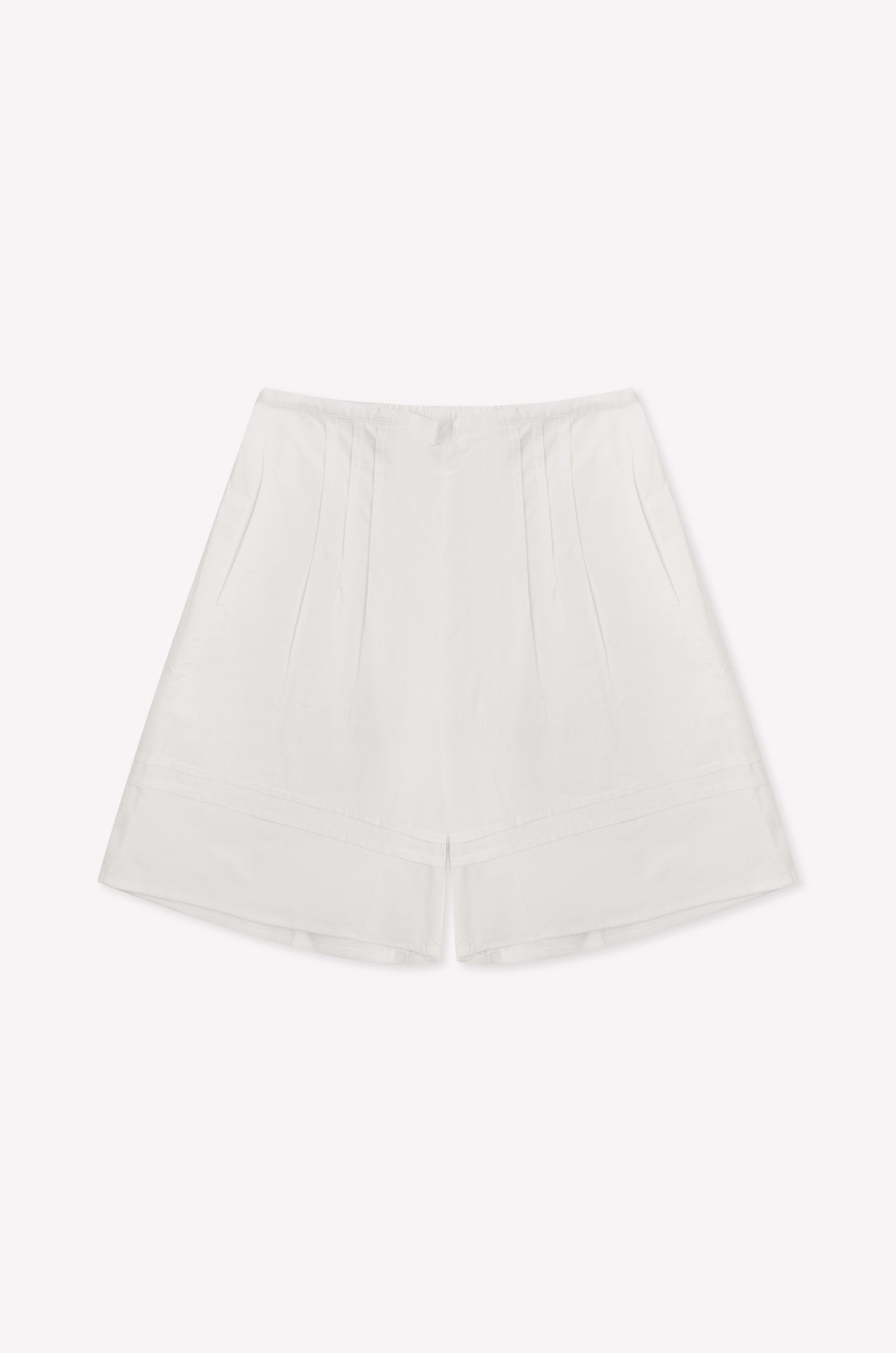 The Pintuck Short - White is a high-waisted cotton poplin short featuring subtle pintuck detailing and a minimalist design, shown against a plain white background.