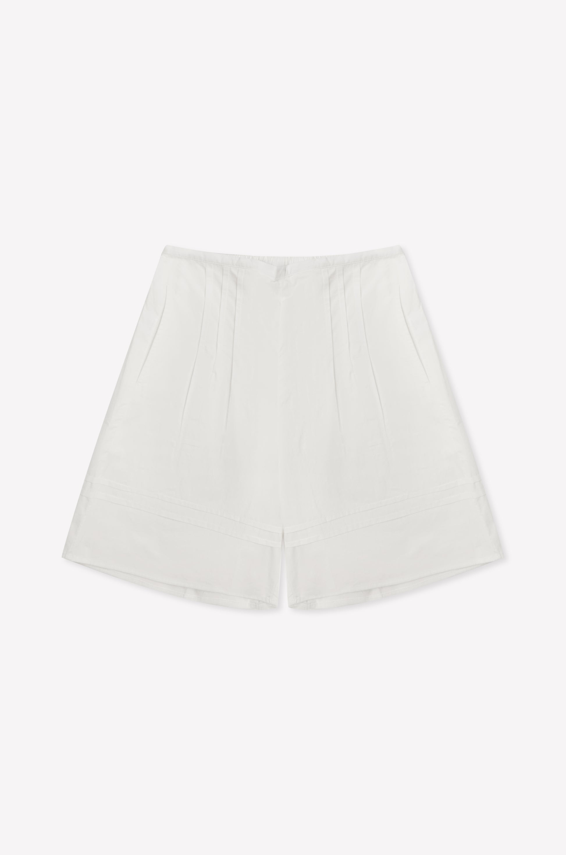 The Pintuck Short - White is a high-waisted cotton poplin short featuring subtle pintuck detailing and a minimalist design, shown against a plain white background.
