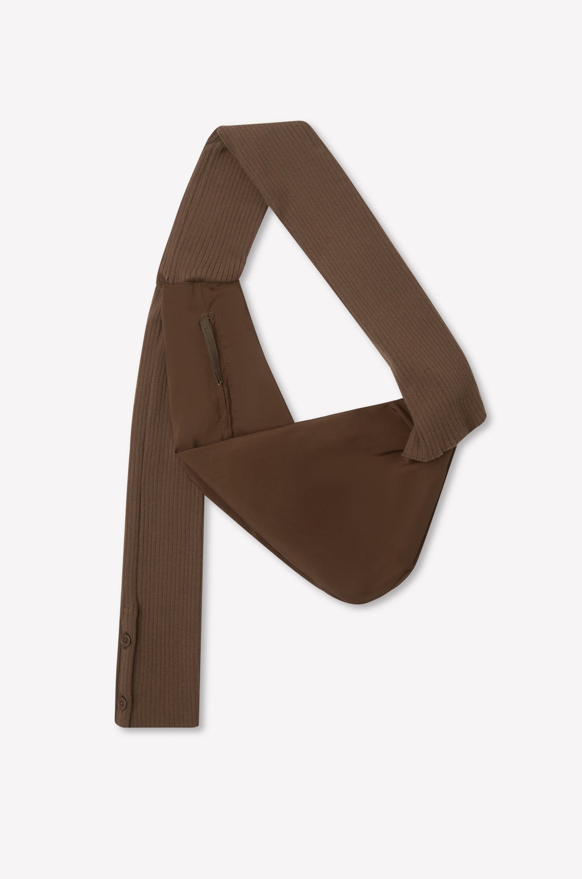The Knit Strap Bag - Hazel is a brown, asymmetrical bag with a wide ribbed knit strap, zippered pocket, and button details on one end, displayed flat on a white background.