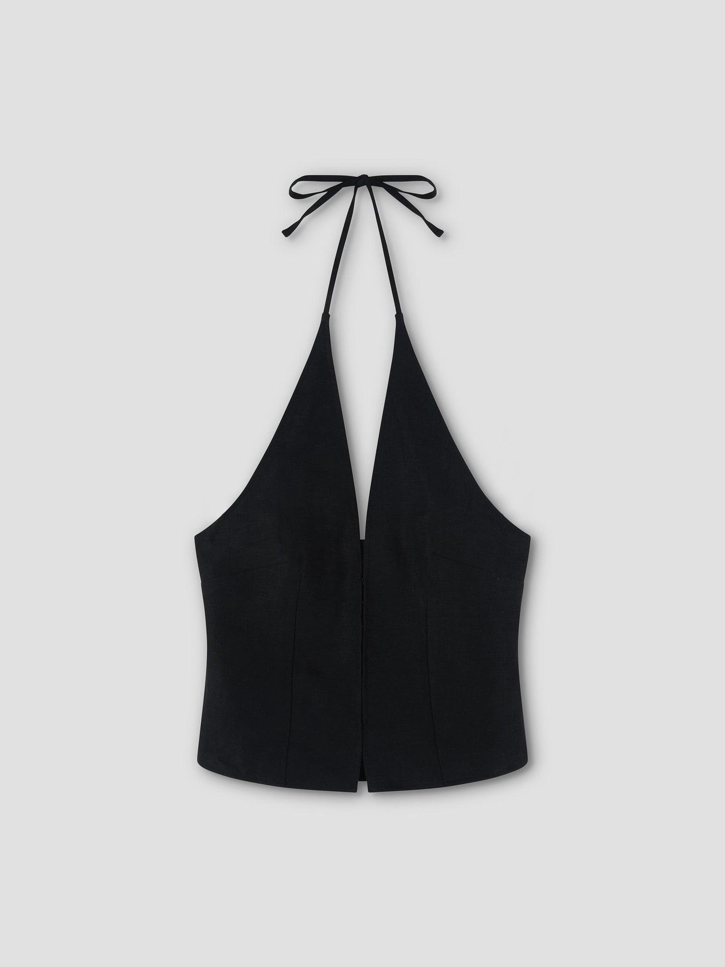 A Close Halter Top - Black by Deiji Studios, featuring a deep V neckline and tie closure at the neck, is displayed flat on a light gray background.