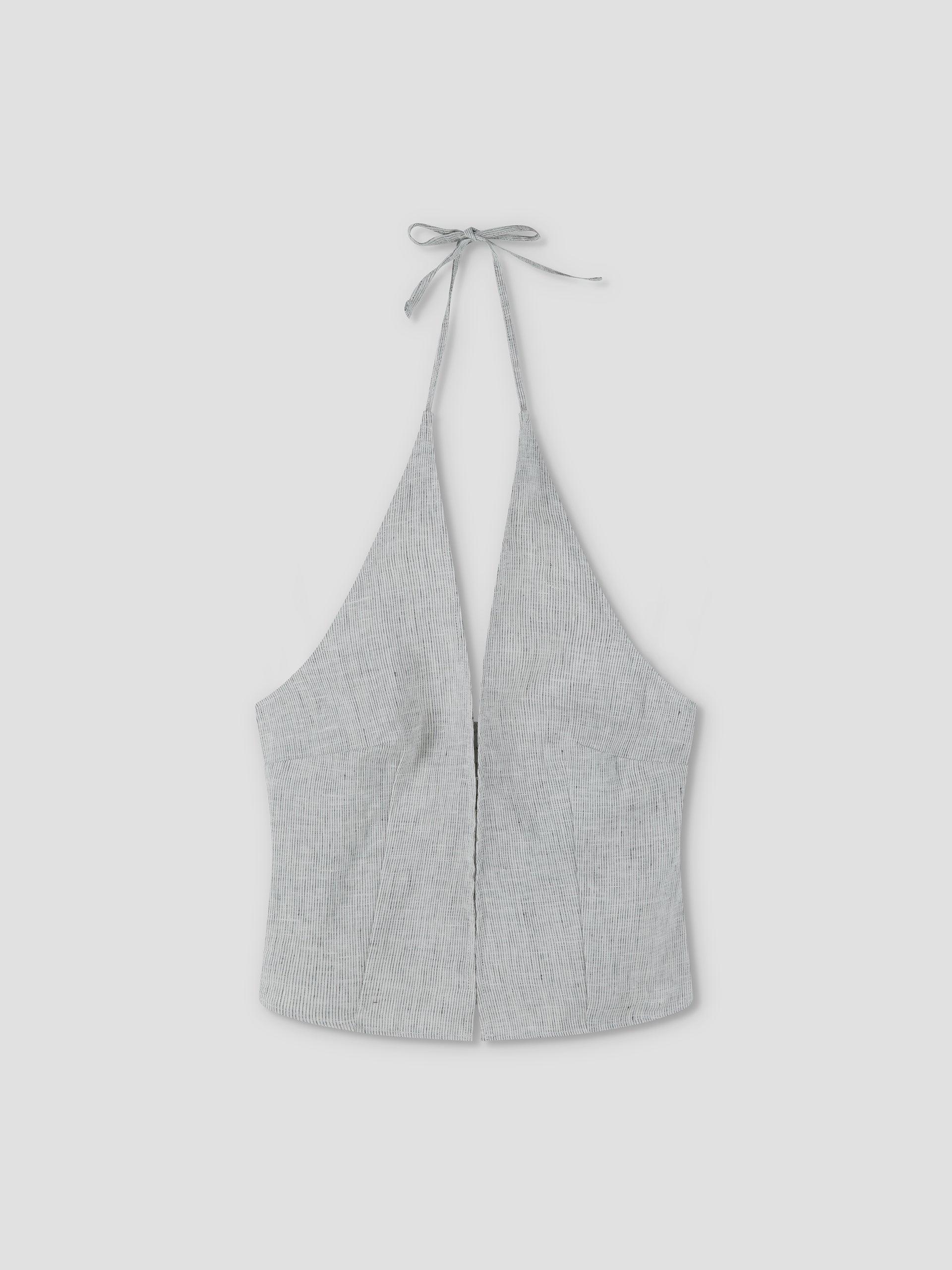 The Close Halter Top - Fine Stripe by Deiji Studios features a light gray hue, deep V neckline, fine stripe pattern, fitted silhouette, and neck tie closure, shown against a plain light background.