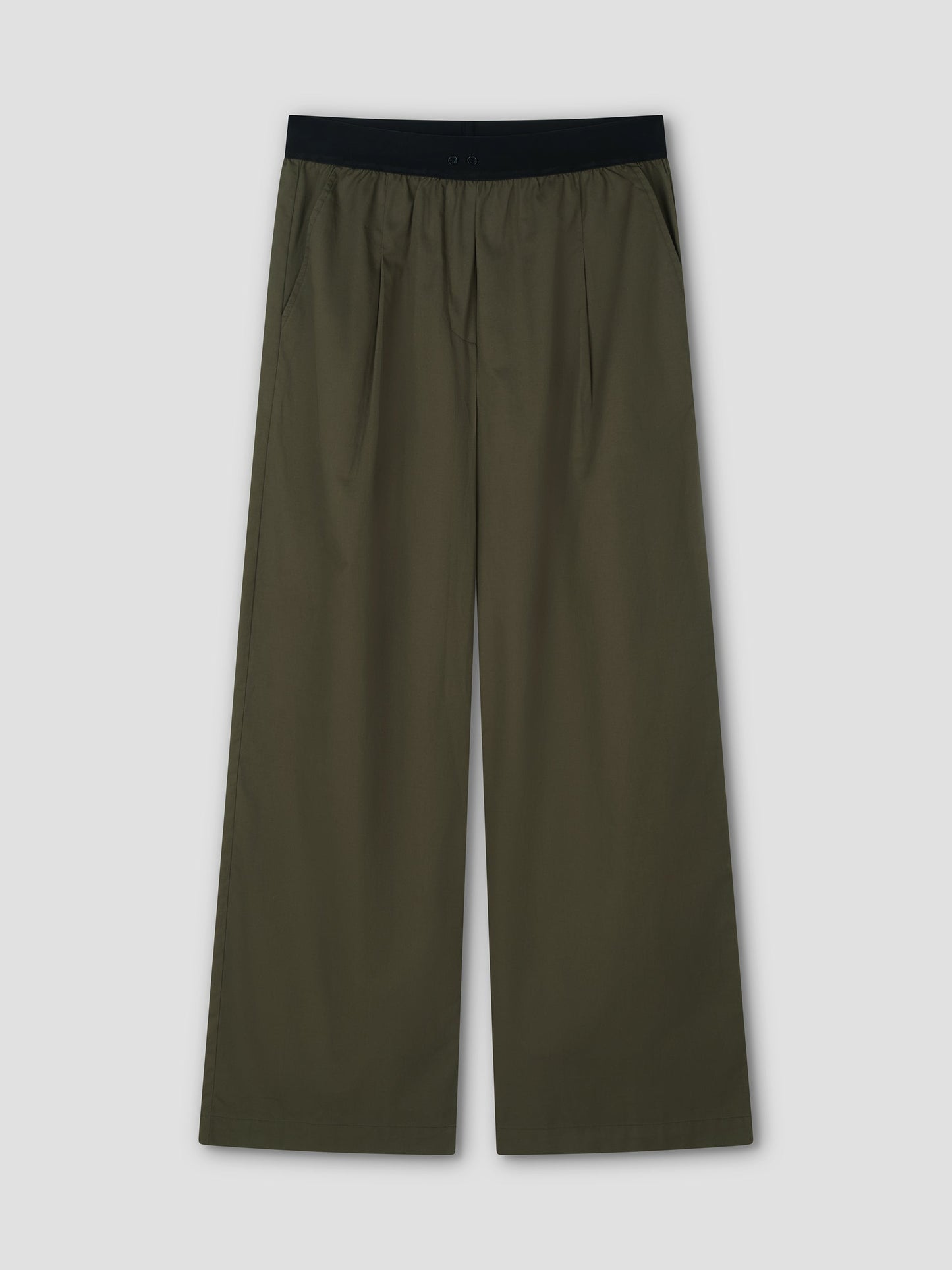The Contrast Waist Pant - Olive by Deiji Studios features a black elastic waistband, relaxed wide-leg fit, side pockets, and front pleats, shown flat on a light gray background.