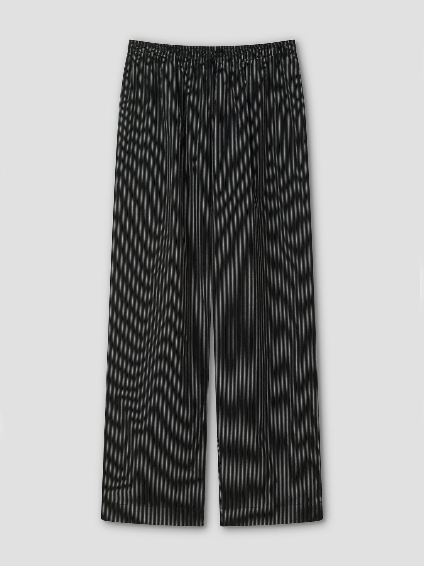 The Ease Trouser - Mono Stripe by Deiji Studios features black ankle-length design with thin white vertical pinstripes, an elastic waistband, and wide legs for a relaxed fit, shown flat on a light gray background.