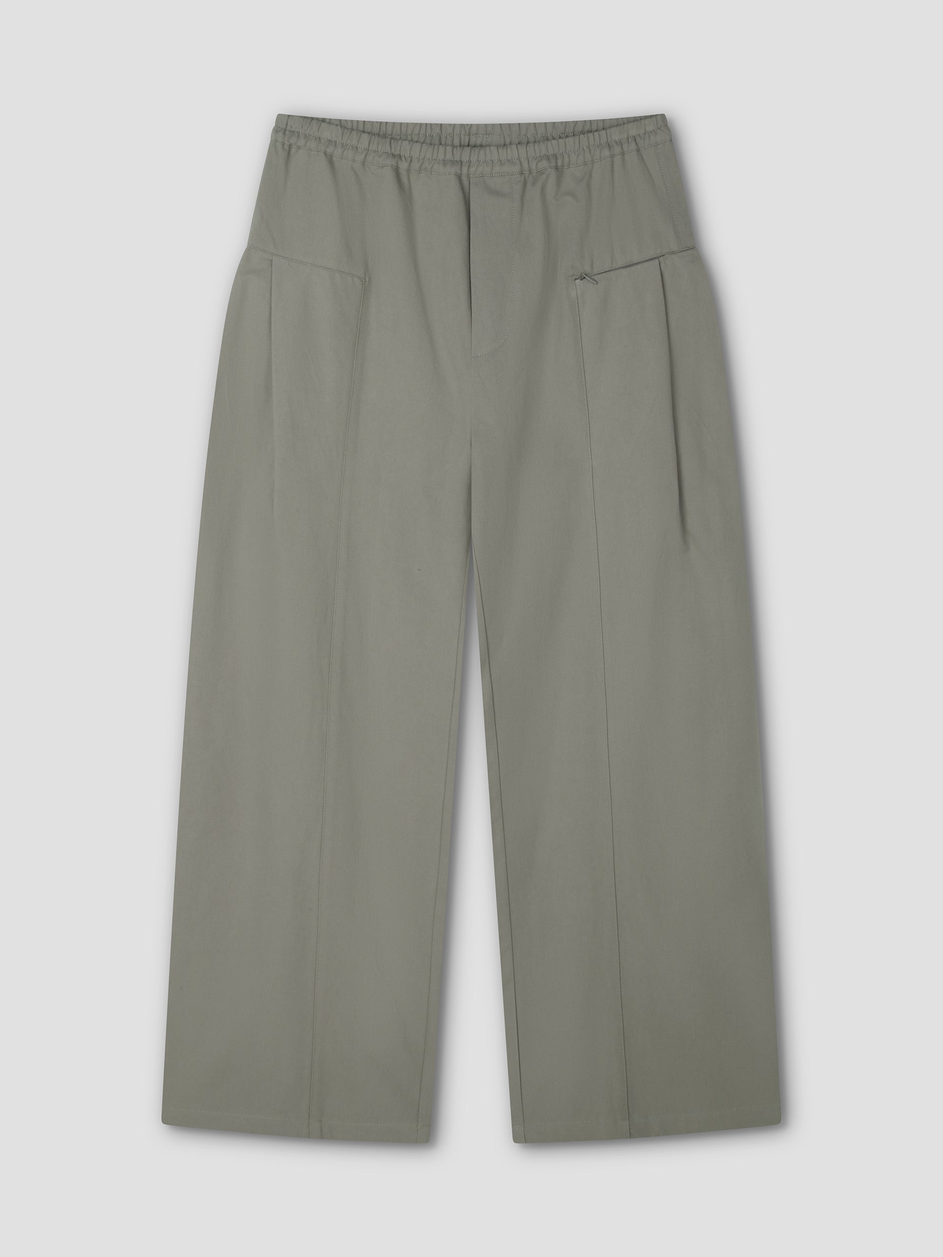 The Pleat Pant - Sage Grey by Deiji Studios features a wide-leg, high-waisted design with an elastic waistband, subtle pleats, and two large front pockets, shown laid flat on a light gray background.